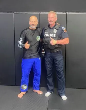 Carlos Machado with a serving officer