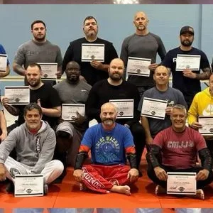 A graduating class holding certificates